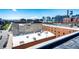 Expansive rooftop view, exhibiting surrounding brick buildings, skylights, and the cityscape beyond at 1863 Wazee St # 4B, Denver, CO 80202