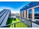 Rooftop deck with artificial grass, modern seating, and views of nearby buildings and the city skyline at 1863 Wazee St # 4B, Denver, CO 80202