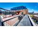 Private rooftop patio featuring sleek lounge seating and a unique hanging swing for outdoor enjoyment at 1863 Wazee St # 4B, Denver, CO 80202