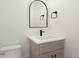 Contemporary powder room with a sleek vanity and arched mirror at 4660 W 9Th Ave, Denver, CO 80204