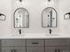 Bathroom featuring a double vanity and arched mirrors at 4660 W 9Th Ave, Denver, CO 80204