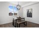 Modern dining area with wood table, benches, and a globe chandelier at 4660 W 9Th Ave, Denver, CO 80204