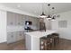 Modern kitchen with gray cabinets, white quartz countertops, and stainless steel appliances at 4660 W 9Th Ave, Denver, CO 80204