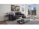 Living area with dark gray sofa, coffee table, and hardwood floors at 4660 W 9Th Ave, Denver, CO 80204