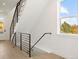 Modern staircase with metal railing leading to upper level at 4660 W 9Th Ave, Denver, CO 80204