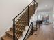 Elegant staircase featuring sleek metal railing and wood steps at 4660 W 9Th Ave, Denver, CO 80204