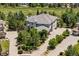 Aerial view of this property showing a spacious driveway, tiled roof, and mature landscaping at 5665 Vistancia Ct, Parker, CO 80134