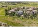 The aerial view reveals a home nestled among mature trees with a sprawling lawn and a scenic community setting at 5665 Vistancia Ct, Parker, CO 80134
