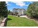 The backyard features a deck with stone supports, a stone retaining wall, and lush landscaping at 5665 Vistancia Ct, Parker, CO 80134