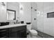 Modern bathroom featuring a stylish vanity, toilet, and a glass-enclosed shower with white vertical tiles at 5665 Vistancia Ct, Parker, CO 80134