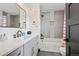 This modern bathroom features a vanity with a black faucet and a shower-over-tub combination at 5665 Vistancia Ct, Parker, CO 80134