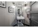 Elegant powder room features modern sink, stylish mirror, unique lighting and decorative wall art at 5665 Vistancia Ct, Parker, CO 80134