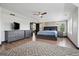 Spacious bedroom with wood floors, a ceiling fan, and a large dresser, offering comfort and style at 5665 Vistancia Ct, Parker, CO 80134