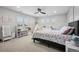 This bedroom features a large window with shutters, ceiling fan, and playful rainbow decorations at 5665 Vistancia Ct, Parker, CO 80134