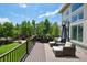The deck features an outdoor dining area and a seating area with plush cushions and scenic backyard views at 5665 Vistancia Ct, Parker, CO 80134