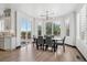 Bright dining room with modern lighting fixture, large windows with outdoor views and access to outdoor deck at 5665 Vistancia Ct, Parker, CO 80134