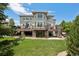 The rear exterior shows a spacious deck with stone supports and large windows offering views of the landscaped yard at 5665 Vistancia Ct, Parker, CO 80134