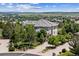 Beautiful two-story home boasts a tiled roof and gorgeous landscaping, set against a backdrop of rolling hills at 5665 Vistancia Ct, Parker, CO 80134