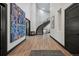 Inviting foyer showcases a curved staircase, wood flooring, and stylish black door and trim at 5665 Vistancia Ct, Parker, CO 80134