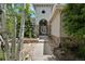 Charming home entrance features a stone facade, arched doorway, and lush greenery at 5665 Vistancia Ct, Parker, CO 80134