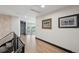 Hallway features wood floors, black trim, and wall art, leading to views of the outdoors at 5665 Vistancia Ct, Parker, CO 80134
