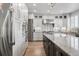 This kitchen features stainless steel appliances, bright cabinets, and a large center island at 5665 Vistancia Ct, Parker, CO 80134