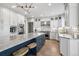 Bright kitchen boasts stainless steel appliances, center island with seating, and stylish lighting fixture at 5665 Vistancia Ct, Parker, CO 80134