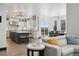 Open-concept kitchen and dining area, with modern appliances, center island, and stylish dining set at 5665 Vistancia Ct, Parker, CO 80134