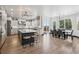 Bright, open kitchen features an expansive island, modern lighting, and stainless steel appliances at 5665 Vistancia Ct, Parker, CO 80134