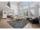 Open floor plan with living room and kitchen, high ceilings, large windows, and comfortable seating area at 5665 Vistancia Ct, Parker, CO 80134