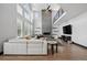 Open living room with soaring ceiling, large windows, fireplace, and comfortable seating area at 5665 Vistancia Ct, Parker, CO 80134