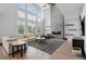 Spacious living room features high ceilings, a fireplace, and large windows with natural light at 5665 Vistancia Ct, Parker, CO 80134