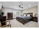 This primary bedroom features a ceiling fan, carpet, and a large window with shutters at 5665 Vistancia Ct, Parker, CO 80134
