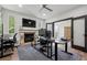 This expansive home office features a stone fireplace and an oversized desk with multiple monitors at 5665 Vistancia Ct, Parker, CO 80134