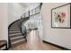 Striking staircase features sleek metal railings, grey carpet, and leads to a bright, open living space at 5665 Vistancia Ct, Parker, CO 80134
