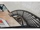 Unique staircase with black metal railings and carpeted steps, complemented by modern stone and wood flooring at 5665 Vistancia Ct, Parker, CO 80134