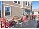 Inviting back patio with a stone fire pit, Adirondack chairs, and outdoor seating, perfect for entertaining at 3395 Starry Night Loop, Castle Rock, CO 80109