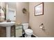 Cozy powder room with stylish pedestal sink, toilet, and decorative wall art at 3395 Starry Night Loop, Castle Rock, CO 80109