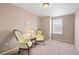 A charming bedroom with two ornate chairs and a side table by the window at 3395 Starry Night Loop, Castle Rock, CO 80109