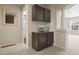 Hallway featuring decorative cabinets, column, and a view into the bathroom and another living space at 3395 Starry Night Loop, Castle Rock, CO 80109