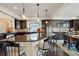 Open concept kitchen with granite island, modern appliances, and dark wood cabinetry at 3395 Starry Night Loop, Castle Rock, CO 80109