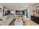 Open concept living room with kitchen view, featuring stylish sofas and decorative elements at 3395 Starry Night Loop, Castle Rock, CO 80109