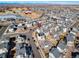 Serene neighborhood aerial view featuring gray roofs, streets, and a nearby park with a pond and red barn at 10512 Truckee St, Commerce City, CO 80022