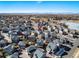 Expansive neighborhood view with gray roofs, streets, a nearby park, and mountains against a clear blue sky at 10512 Truckee St, Commerce City, CO 80022