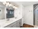 Dual vanity bathroom with modern fixtures and a luxurious glass shower at 10512 Truckee St, Commerce City, CO 80022