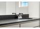 Modern bathroom vanity with a sleek gray countertop and stylish fixtures and mirror at 10512 Truckee St, Commerce City, CO 80022