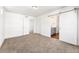 Bedroom with neutral carpet and barn door to an en-suite bathroom at 10512 Truckee St, Commerce City, CO 80022