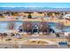 Image of the community clubhouse featuring a frozen pond and mountain views at 10512 Truckee St, Commerce City, CO 80022