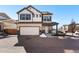 Charming two-story home with stone accents, a paved driveway, and a welcoming front porch at 10512 Truckee St, Commerce City, CO 80022