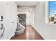 Bright entryway with hardwood floors, a staircase, and a glimpse of the fireplace at 10512 Truckee St, Commerce City, CO 80022